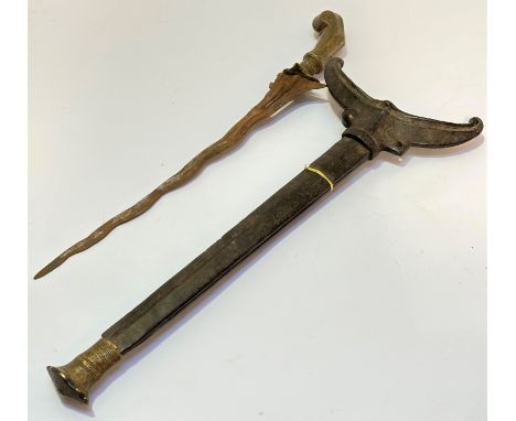 A Kris with brass handle to top and steel wavy blade (L:43cm) complete with treen scabbard with similar brass decorated mount