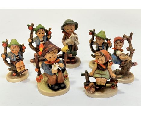 A collection of German Hummel pottery figures including three Apple Tree Boys, an Apple Tree Girl, Just Resting, Boy with Dai