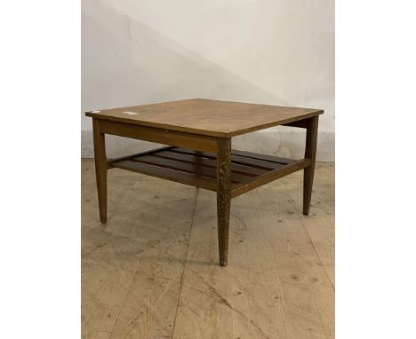 A mid century teak lamp table, the square top over slatted under tier, raised on square tapered supports, H34cm, W51cm D51cm