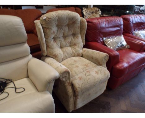 Manual reclining easy chair in cream and floral patterned material 