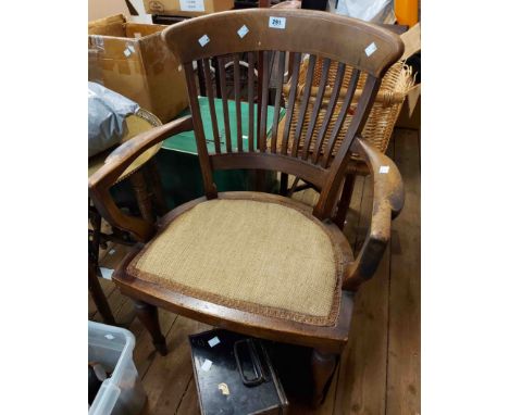 An Edwardian mahogany and strung shaped stick back elbow chair with upholstered seat panel, set on turned front legs