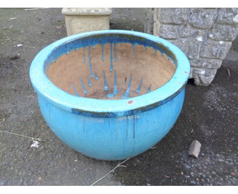 A large blue glazed garden planter