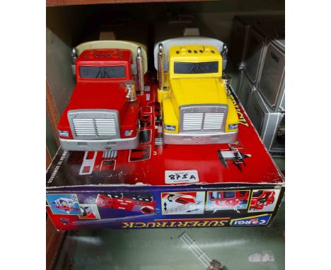 A bag containing a boxed Corgi Supertrucks fire engine and two other model trucks
