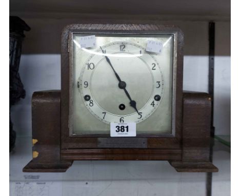 A vintage stained oak cased mantel clock with Clarion eight day chiming movement - bearing presentation plaque
