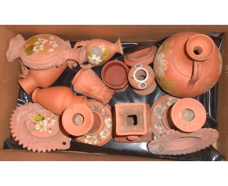 A box containing a quantity of Torquay painted terracotta ware including jugs, wall hangings, vases, pair of candlesticks, et