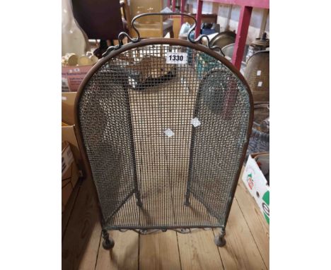 A brass framed and mesh folding firescreen