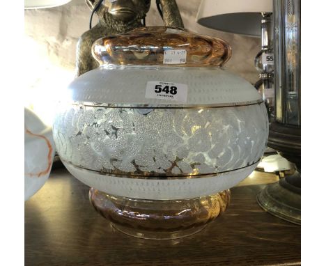 A vintage glass lamp shade with amber and frosted finish