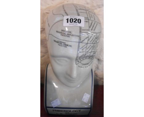 A modern ceramic phrenology head with black decoration on crackle glaze ground