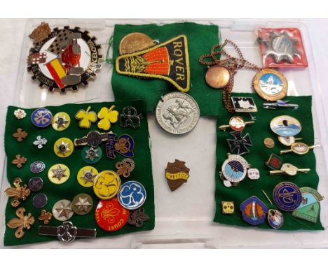 A folder containing a quantity of Girl Guide, Scout and other enamel and metal badges including Girl Adventurers, etc.