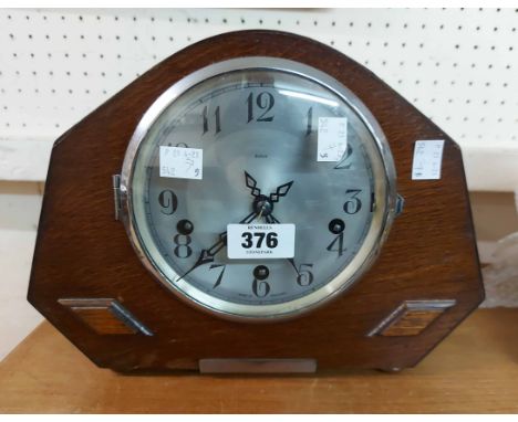A vintage stained oak cased mantel clock with Enfield eight day chiming movement