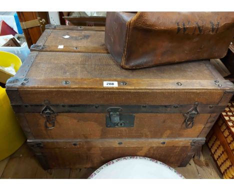 A 61cm old travelling trunk with metal binding and canvas weather coating - internal tray missing