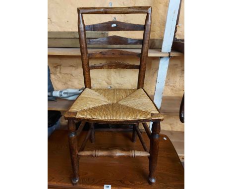 An antique ladder back standard chair with later woven rush seat - sold with an elm seated bow chair