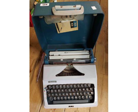 A vintage Erika portable typewriter in plastic hard carry case