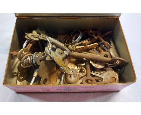 A vintage Louis Sherry, New York chocolate tin containing a quantity of old keys, clock keys, etc.