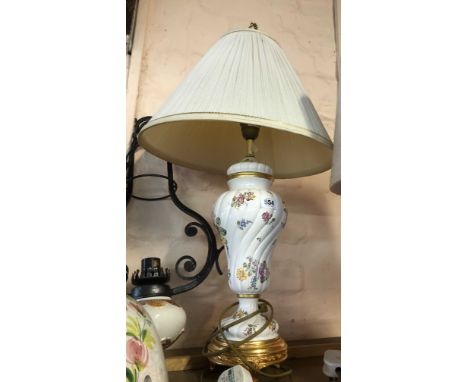 A Louis Nichole for Franklin Mint table lamp with pottery body decorated with transfer printed floral sprays on a gilt metal 