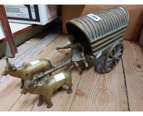 An Eastern cast brass model of an ox wagon with two oxen and driver