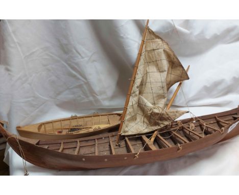 A large wooden model boat - sold with a smaller similar
