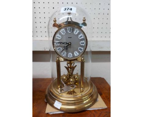 A vintage Kundo brass anniversary clock with ball pendulum under perspex dome