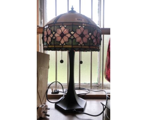 A modern Tiffany style lamp with bronzed effect base and glass shade