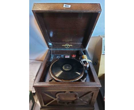 A wooden cased Colombia Viba-Tonal Grafonola gramophone with fretwork speaker and lift-top lid containing a box and tin of ne