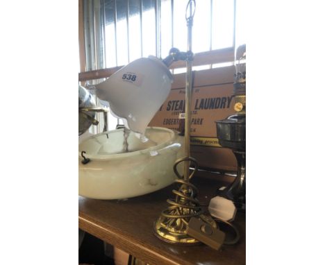 A modern brass lamp of pedestal form with opaque glass shade