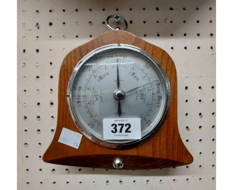 A small bell shaped oak framed Shortland Bros aneroid wall barometer