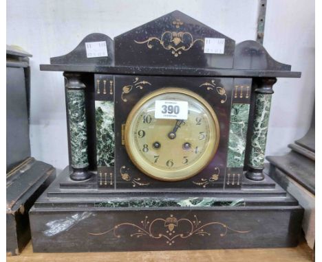 A late Victorian black slate and green marble cased mantel clock of architectural design with eight day gong striking movemen