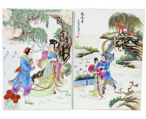 A pair of 20th Century Chinese porcelain panels, each depicting a pair of lovers in a landscape with hand painted calligraphi