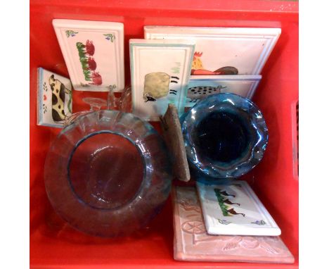 A crate containing two blue glass vases and a quantity of ceramic tiles