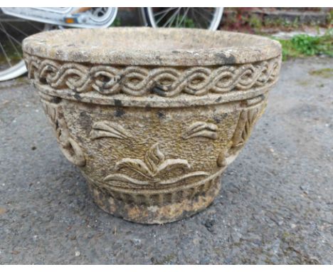 A concrete garden planter of round bowl form, with moulded swag decoration