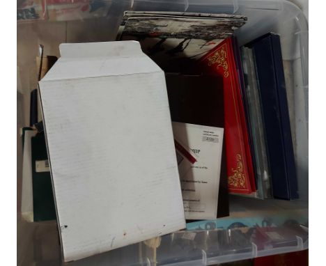 A crate containing a quantity of coin sets, Royal commemorative medallions, etc.