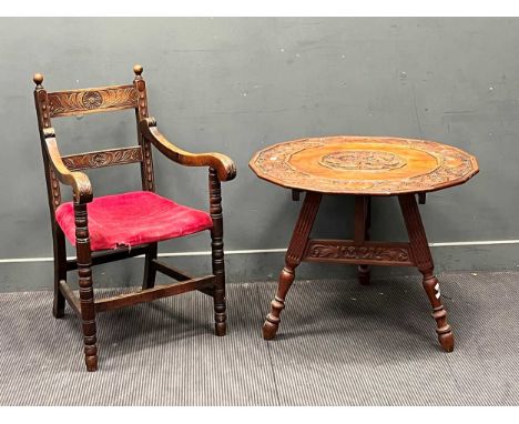 A polygonal table set on three carved legs, the top carved with central figure vignette and overscrolled acanthus border. Tog