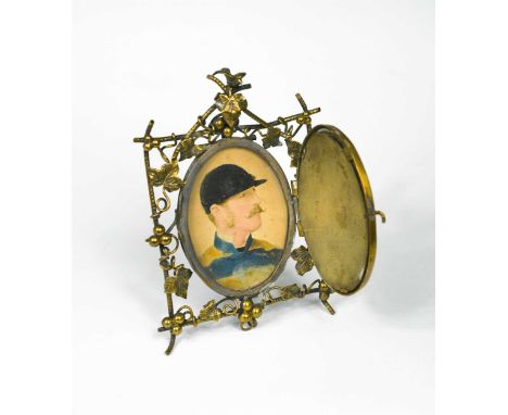 A portrait miniature of a jockey, overpainted photograph by Elliott and Fry, in an ornate mirror-fronted gilt frame with vine