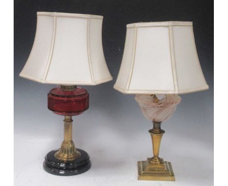 Two brass lamps one with ruby glass resovoir, the other with swirled glass. (2)