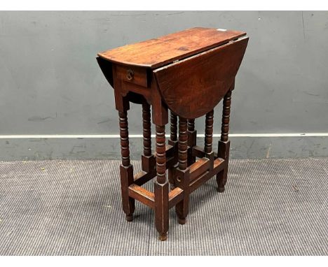 A small late 19th century Sutherland drop leaf table with bobbin turned leg, made from the timber from Queen Victoria's royal