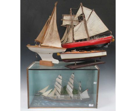 A cased model ship together with various other model yachts and boats