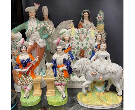 A collection of Staffordshire figures, most with old damage, to include a Highland group pocket watch stand, a gardener, a Hi