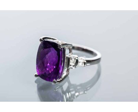 AMETHYST AND WHITE GEM SET RING
with a central cushion shaped amethyst measuring 14 x 10mm, on white gem set shoulders, marke