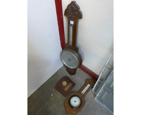 An Edward VII inlaid mahogany barometer, an oak aneroid barometer and a Zavro propeller wall clock