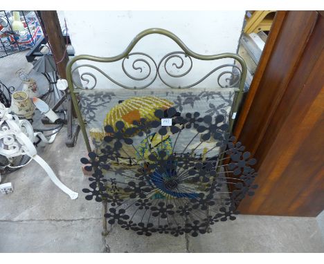 A brass embroidered fire screen and decorative wall plaque