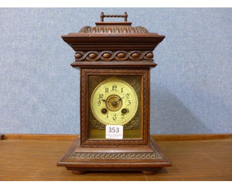 A 19th Century French carved walnut mantel clock