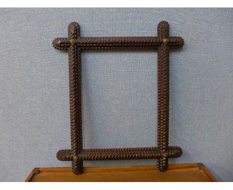 A tramp art picture frame