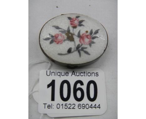 An early 20th century enamel and brass pill box. 
