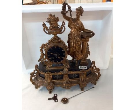 An ornate gilt figural clock in the Greek style 