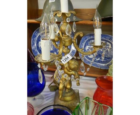 A candelabra style gilt table lamp supported by a cherub. COLLECT ONLY. 