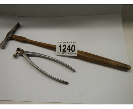 A small watchmakers hammer and a pair of small adjustable pliers. 