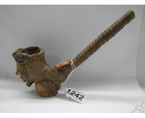 An unusual vintage pottery pipe of a head impressed with coloured stones. 