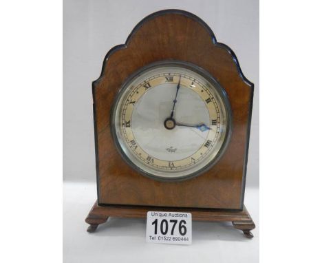 A good figured walnut Elliot mantel clock on bracket feet, 18 cm tall. 