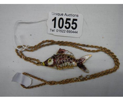 A mid 20th century enamel articulated fish pendant on yellow metal chain. 