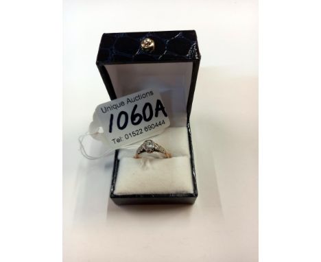 A vintage white stone set ring shoulders set with hearts in 9ct gold 